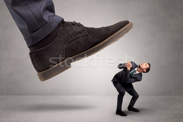 Small man trampled by the great power Stock photo © ra2studio