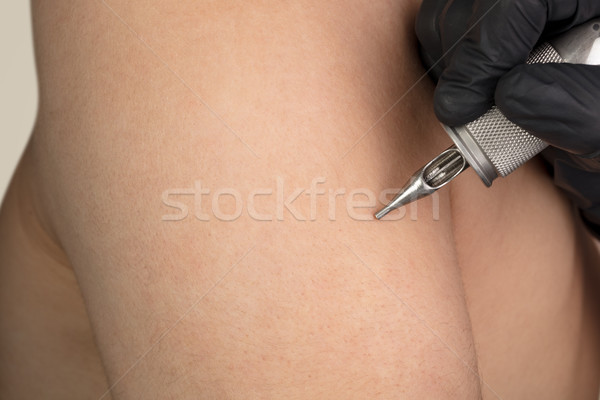 Hand tattooing on naked clear skin Stock photo © ra2studio