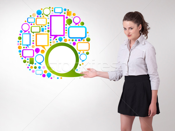Young business woman presenting colourful speach bubble Stock photo © ra2studio