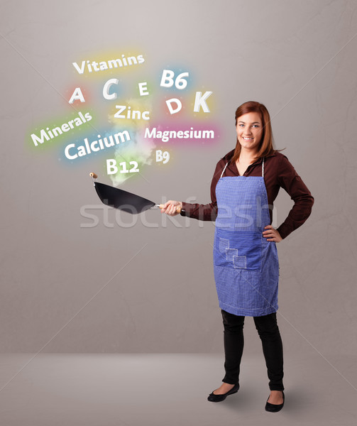 Fiatal nő főzés vitaminok ásványok csinos étel Stock fotó © ra2studio