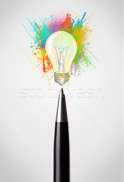 Pen close-up with colored paint splashes and lightbulb Stock photo © ra2studio