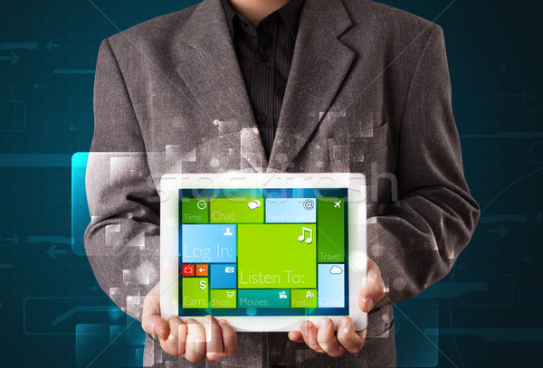 Young businessman holding a tablet with modern software operational system Stock photo © ra2studio