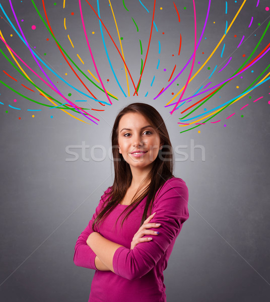 Young girl thinking with colorful abstract lines overhead Stock photo © ra2studio