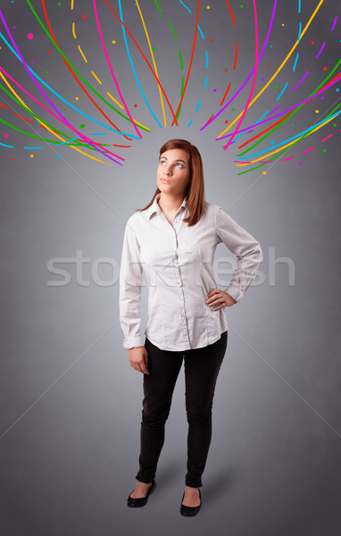 Young girl thinking with colorful abstract lines overhead Stock photo © ra2studio