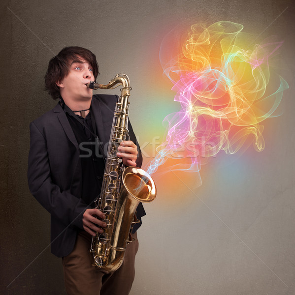 Attractive musician playing on saxophone with colorful abstract  Stock photo © ra2studio