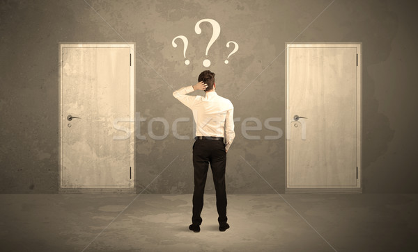 Businessman standing in front of doors Stock photo © ra2studio