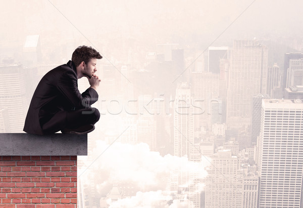 Office worker sitting on rooftop in city Stock photo © ra2studio