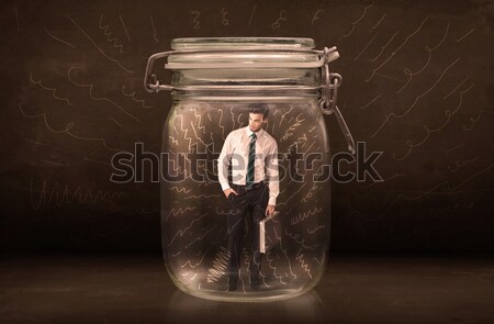 Businessman inside a jar with powerful hand drawn lines concept Stock photo © ra2studio