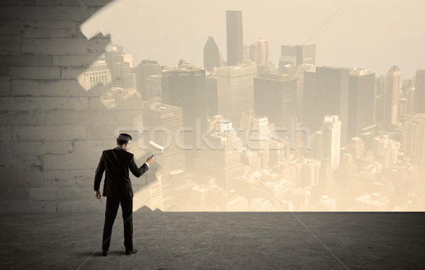 Salesman painting city scape on wall Stock photo © ra2studio