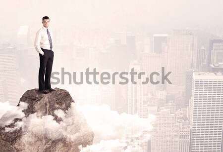 Feliz empresario pie piedra superior elegante Foto stock © ra2studio