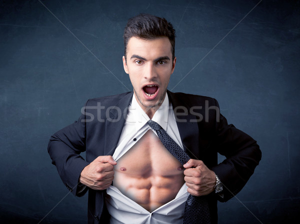 Stock photo: Businessman tearing off shirt and showing mucular body