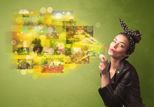 Cute girl blowing colourful glowing memory picture concept Stock photo © ra2studio