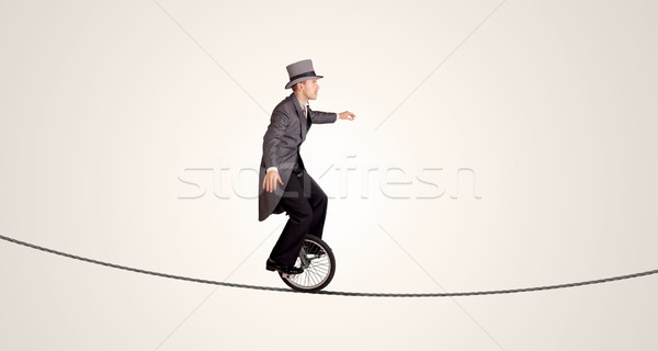 Сток-фото: Extreme · деловой · человек · верховая · езда · одноколесном · велосипеде · веревку · бизнеса