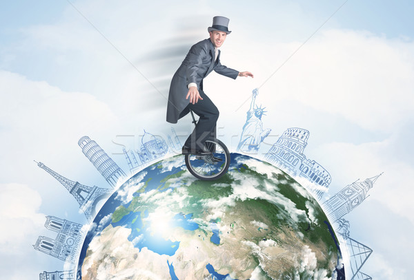 Man riding unicycle around the globe with major cities Stock photo © ra2studio