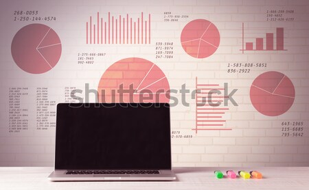 Laptop on office desk with sales pie charts Stock photo © ra2studio