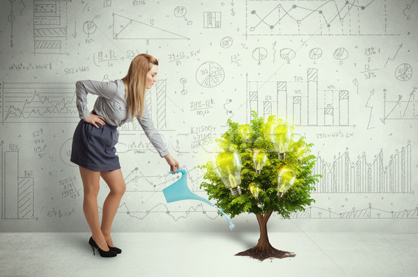 Business woman pouring water on lightbulb growing tree Stock photo © ra2studio