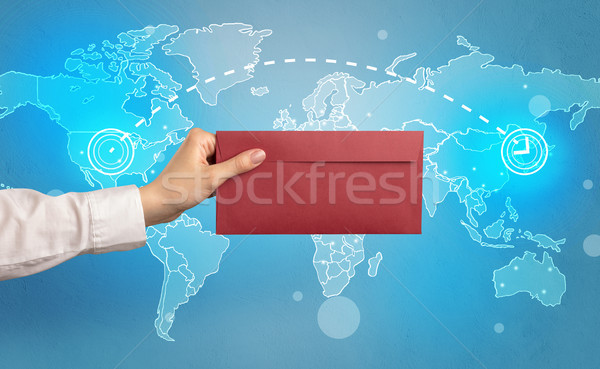 Hand holding envelope with global concept Stock photo © ra2studio