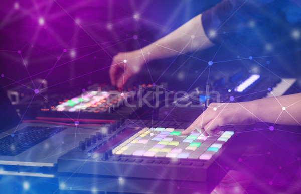 Hand mixing music on midi controller with connectivity concept Stock photo © ra2studio