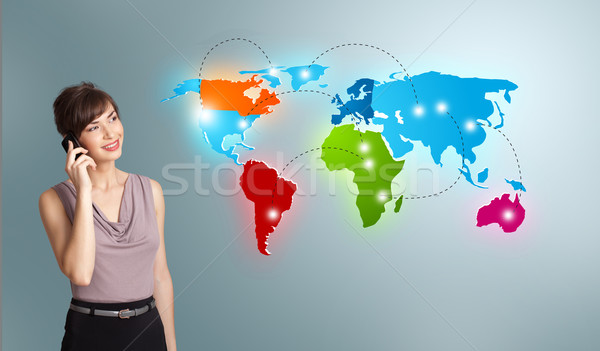 young woman making phone call with colorful world map Stock photo © ra2studio