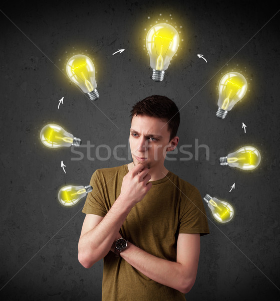 Young man thinking with lightbulb circulation around his head Stock photo © ra2studio