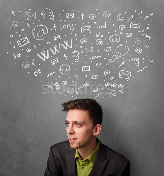 Businessman thinking with social network icons above his head Stock photo © ra2studio