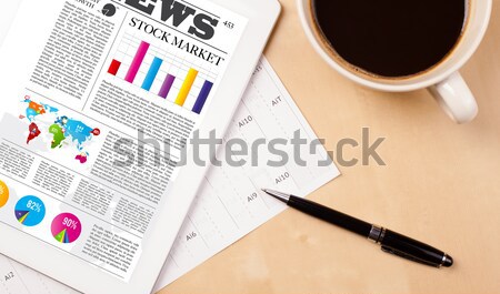 Tablet pc shows news on screen with a cup of coffee on a desk Stock photo © ra2studio