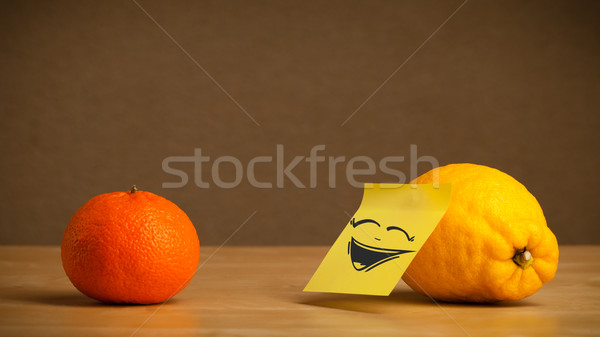 Lemon with post-it note laughing on orange Stock photo © ra2studio