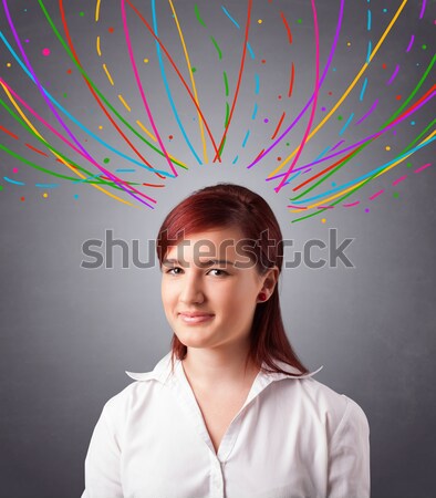 Young girl thinking with colorful abstract lines overhead Stock photo © ra2studio