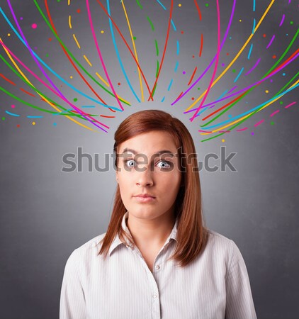 Young girl thinking with colorful abstract lines overhead Stock photo © ra2studio