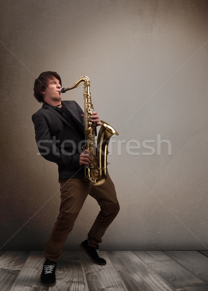 Young musician playing on saxophone Stock photo © ra2studio