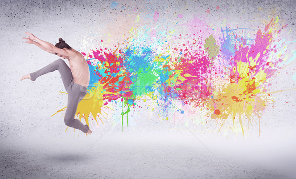 Stock photo: Modern street dancer jumping with colorful paint splashes