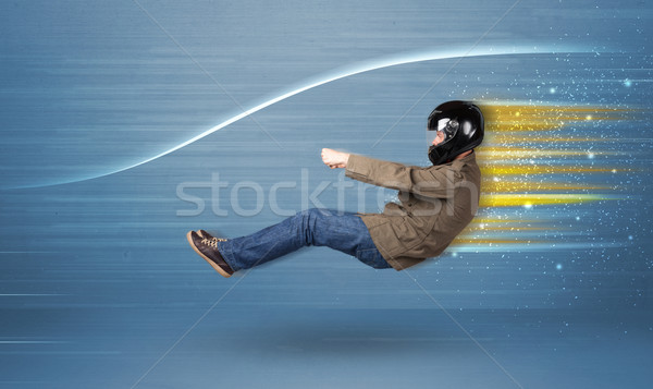Young man driving in imaginary fast car with blurred lines  Stock photo © ra2studio