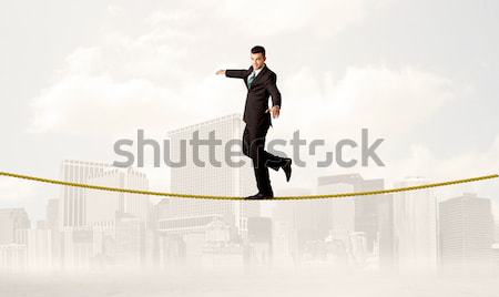 Stock photo: Energetic business man jumping over a bridge with gap