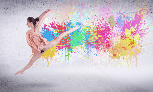 Modern street dancer jumping with colorful paint splashes Stock photo © ra2studio