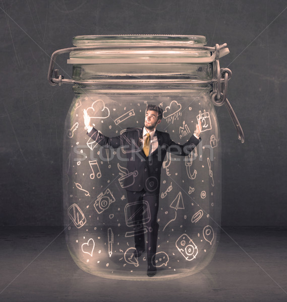 Stock photo: Business man captured in glass jar with hand drawn media icons c