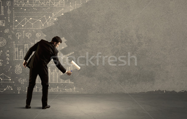 Salesman painting over charts on wall Stock photo © ra2studio