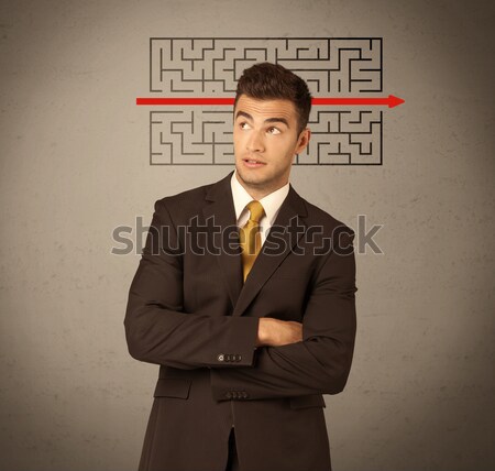 Handsome business guy solving maze Stock photo © ra2studio