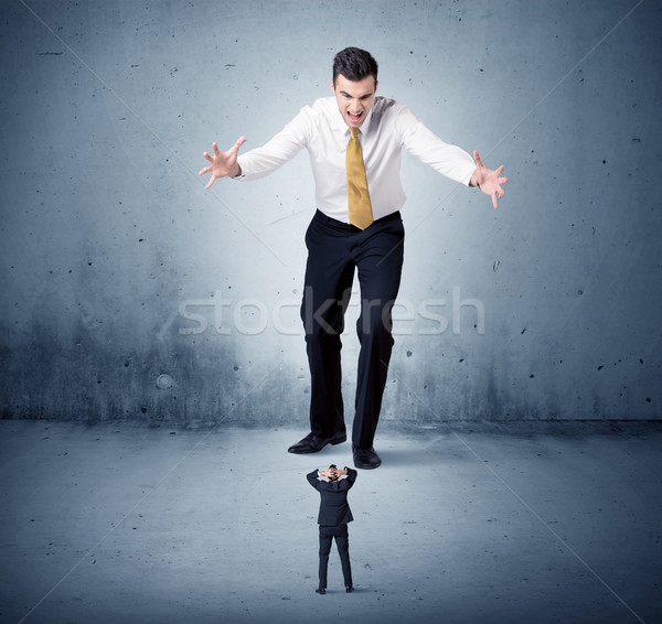 Angry huge business man lokking at small guy Stock photo © ra2studio