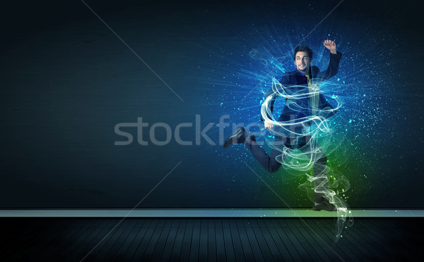 Talented cheerful businessman jumping with glowing energy lines Stock photo © ra2studio