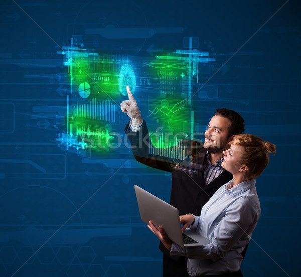 Young business couple pressing modern technology panel with fing Stock photo © ra2studio
