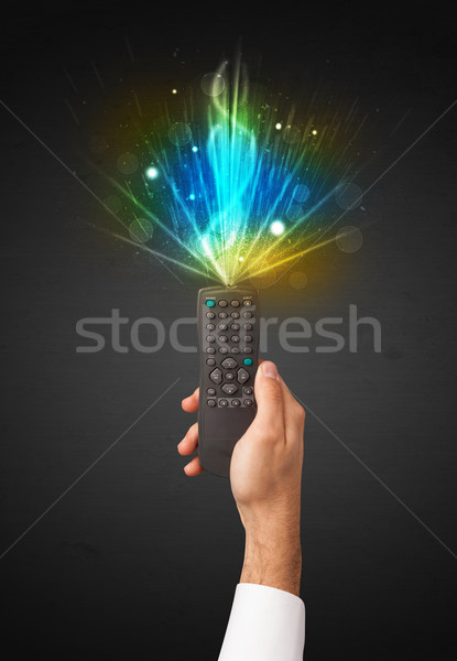 Hand with remote control and explosive signal Stock photo © ra2studio