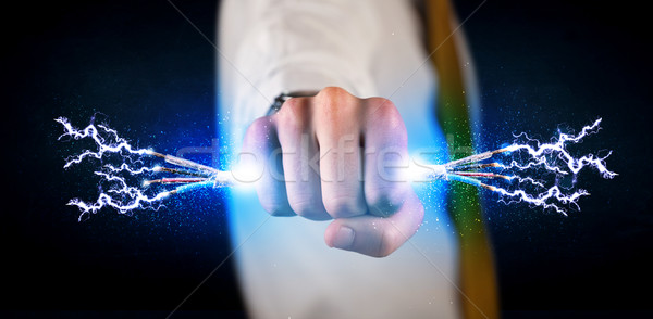 Business person holding electrical powered wires Stock photo © ra2studio
