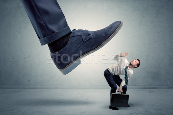 Employee getting trampled by big shoe Stock photo © ra2studio