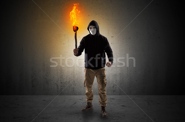 Man walking in an empty space with burning flambeau Stock photo © ra2studio