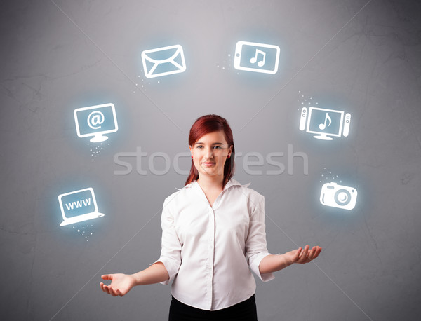 pretty girl juggling with elecrtonic devices icons Stock photo © ra2studio