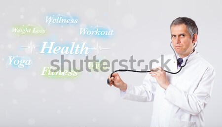 Stock photo: young lady standing and holding a phone with copy space