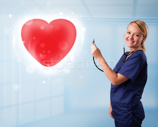 Jeunes infirmière guérison rouge coeur joli Photo stock © ra2studio