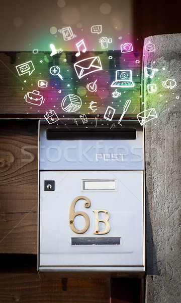 Colorful icons and symbols bursting out of a mailbox Stock photo © ra2studio