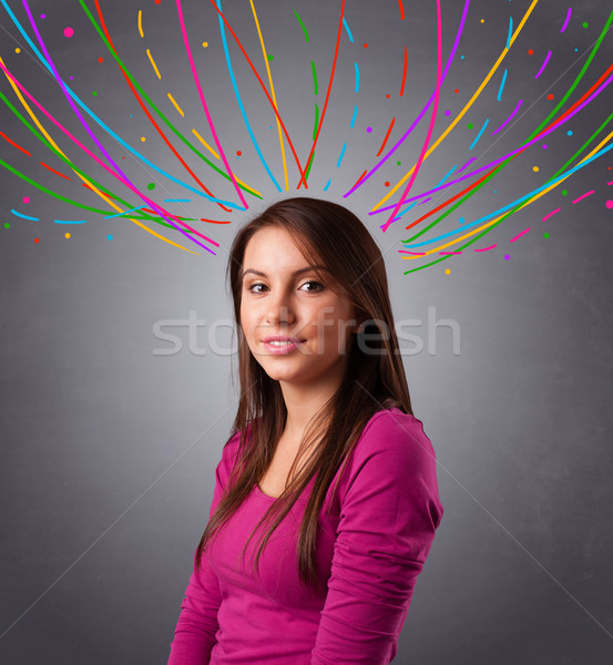 Young girl thinking with colorful abstract lines overhead Stock photo © ra2studio