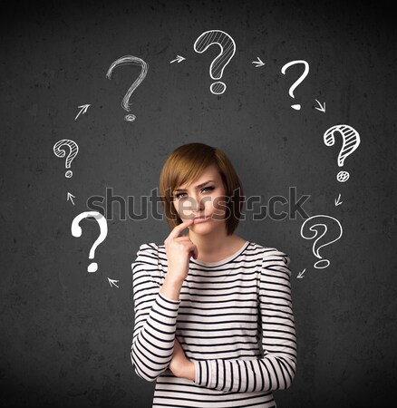 Young woman thinking with question mark circulation around her h Stock photo © ra2studio